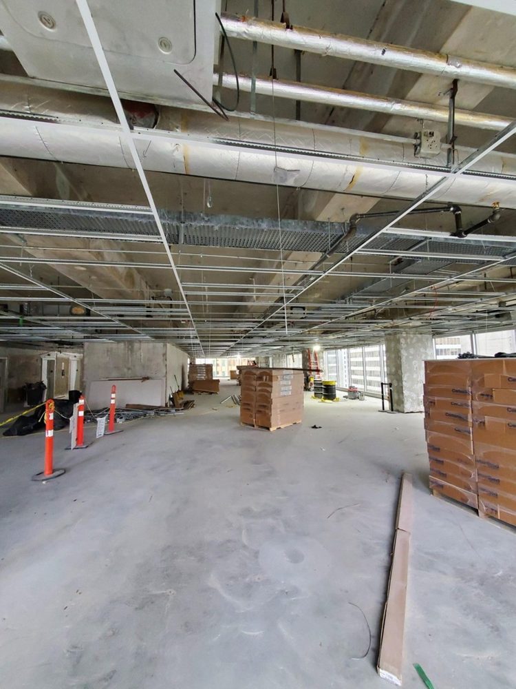 Suspended ceiling grid below a visibly coated structural deck at Royal Centre, Vancouver; Rambo project photograph