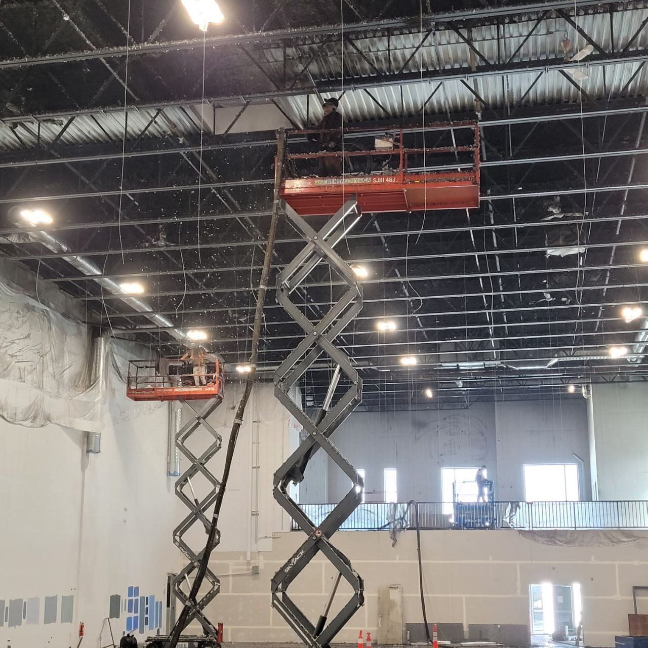 Representative commercial project view with elevated-access crews